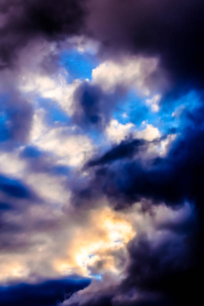 istock The sky is filled with dark clouds and the sun is shining through them 2164602373