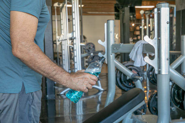 istock Hand of Middle-aged Man Holding Vitamin Bottle Focused on Strength Training 2164602918