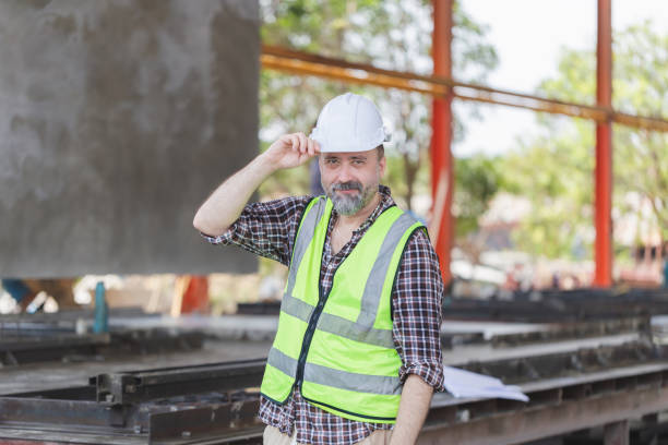 istock Cheerful engineer man on construction site, Caucasian foreman worker checking project at precast concrete factory site 2164605100