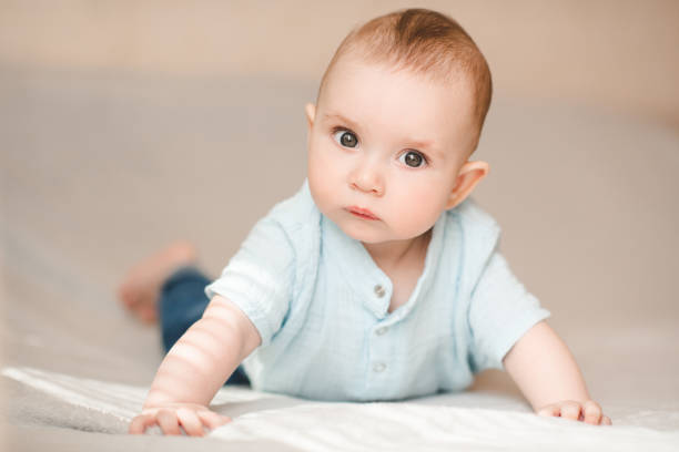 istock Cute baby boy in bed close up 2164605248
