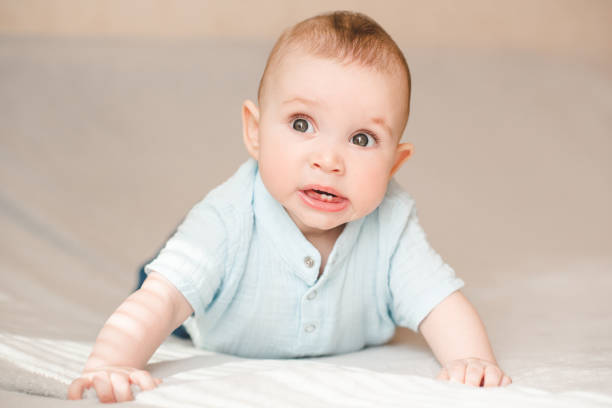 Cute baby boy in bed close up