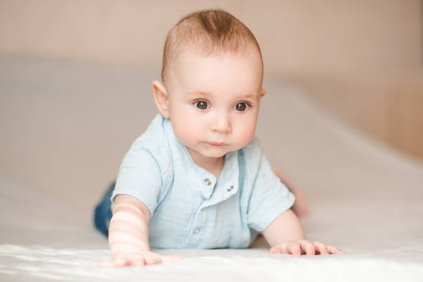 istock Cute baby boy in bed close up 2164605317