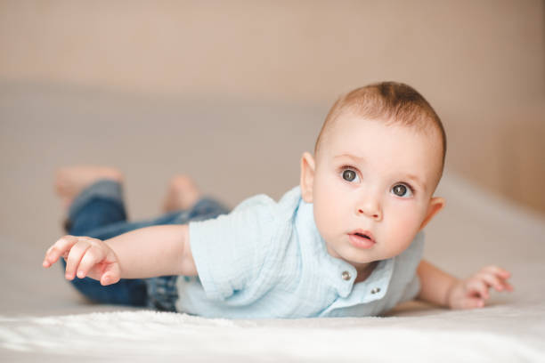 istock Cute baby boy in bed close up 2164605356