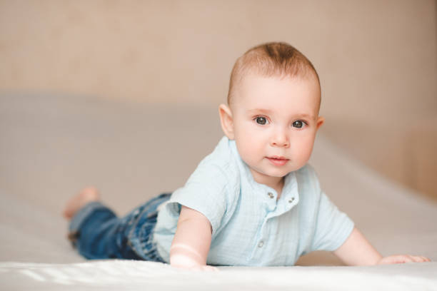 istock Cute baby boy in bed close up 2164605358