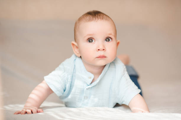 istock Cute baby boy in bed close up 2164605362