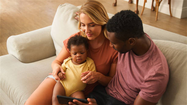 istock Family Enjoying Quality Time Together While Watching Something on a Smartphone at Home 2164606070