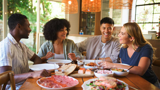 istock Friends Enjoying a Lively Dinner Gathering at Home on a Warm Evening 2164606505