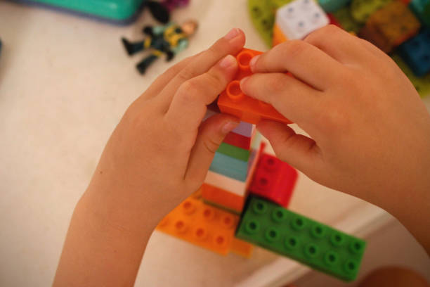 istock Child's hands playing with building toys 2164608324