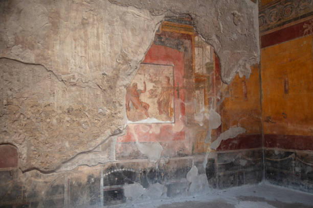 detail of the fresco in Pompeii with winged griffin on a red background Pompeian
