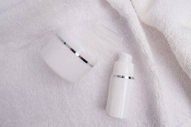 istock Container for cream, shampoo, toiletries, spa. Unbranded white plastic bottles. Bottle with a dispenser for cosmetic products. Skin care and beauty concept. Mockup style, copy space 2164611471