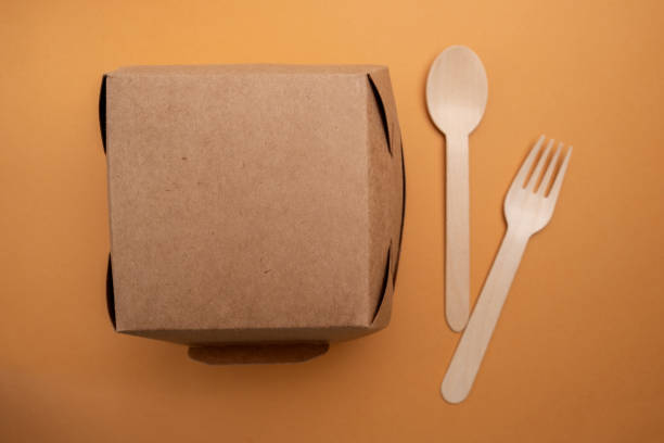 istock Kraft paper tableware: cups, food boxes, isolated on a light background. A set of various disposable tableware. Recycling and zero waste concept. Mock up 2164611736