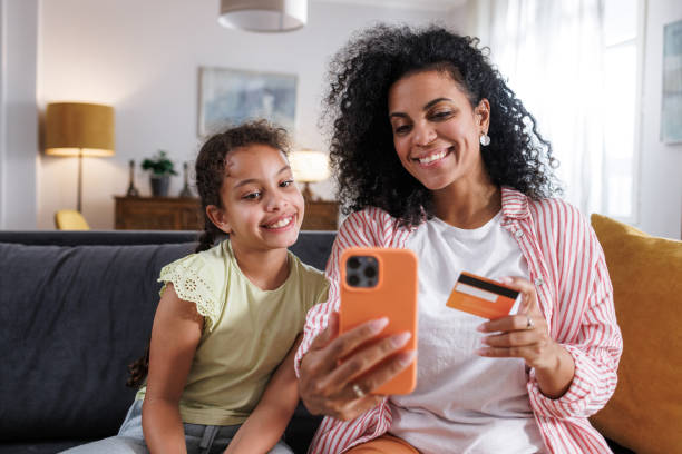 istock Mother and daughter making an online purchase 2164612404