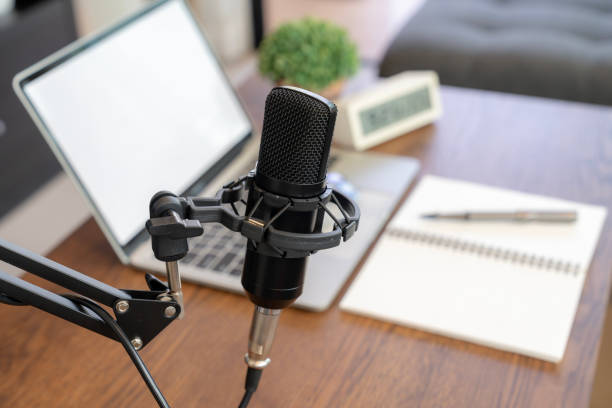 istock Concept of podcast, broadcasting or recording home studio with microphone and notebook or laptop. 2164617618