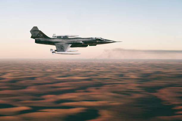 A fifties to sixties F-104 Starfighter fighter jet streaks across the sky above a desert landscape. Scale model photography.