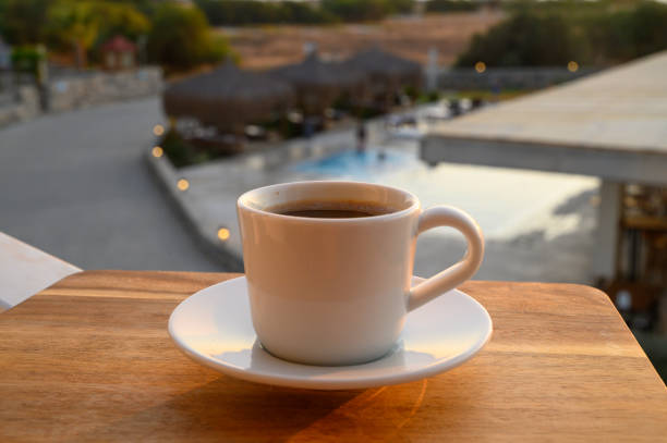 Cup of coffee next to a swimming pool