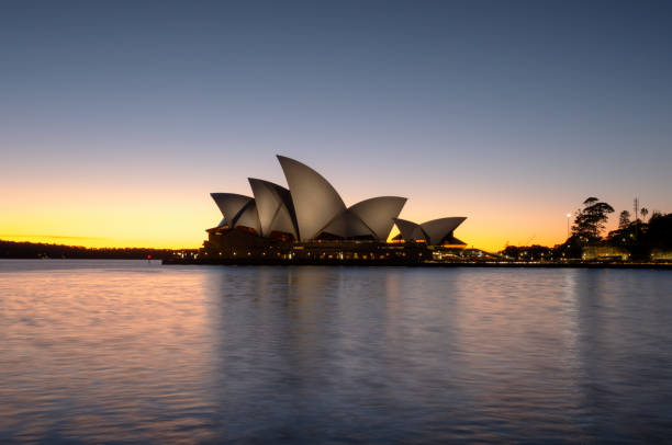 Sydney Australia - August 5, 2017: Early morning in Sydney, and the iconic Opera House and a glorious pre-dawn sky are reflected in the waters of Circular Quay.