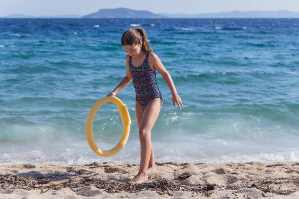 Child carrying inflatable ring on the beach