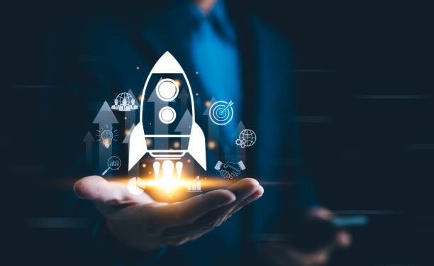 istock Business growth concept. Professional businessman projecting a holographic rocket symbolizing startup success and growth acceleration. Rising earnings, increasing financial profits, Wealth fast, 2164627213