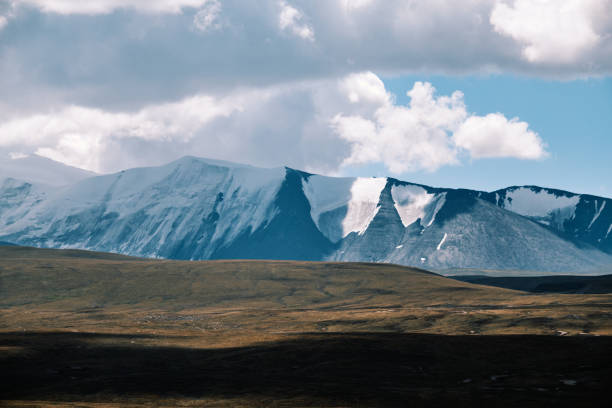 Atmospheric landscape: shadows of clouds on mountain peaks