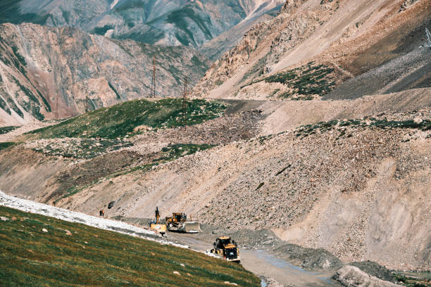 istock Removing mudflow on dirt road in mountains. Barskoon pass, Kyrgyzstan 2164628247