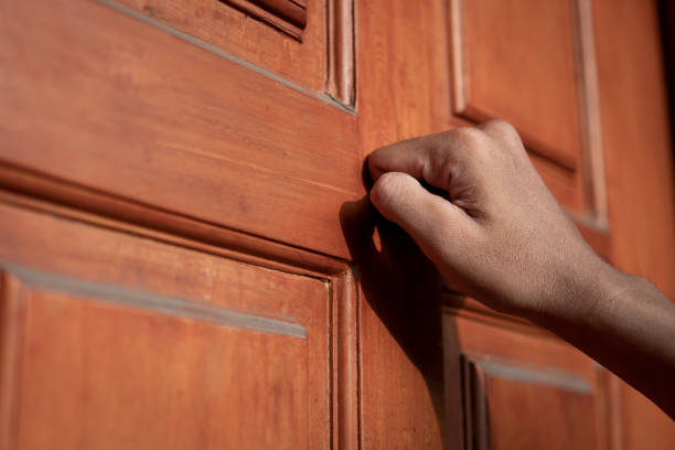 istock Hand knocking on the door 2164628822