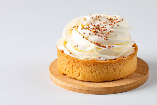 istock Lemon tartlets with whipped cream, sprinkles and chocolate chips on white background 2164629194