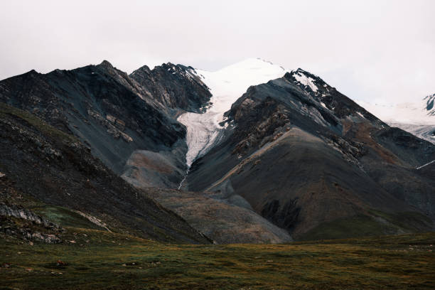 istock Snow cap of mountain peak in clouds 2164629644