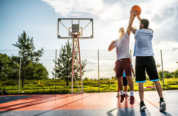 istock Two young men playing basketball 2164630359