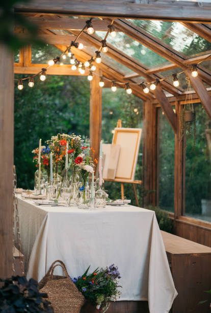 istock decorated greenhouse in trendy wedding setting with dinner table, candles and candle lights. 2164630554