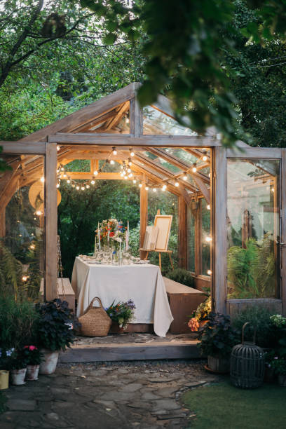 istock decorated greenhouse in trendy wedding setting with dinner table, candles and candle lights. 2164630564