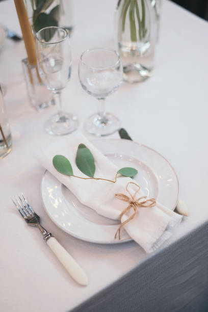 istock Table setting with napkin on empty white plate, wineglasses and cutlery on table, copy space. Place setting at wedding reception. Table served for banquet 2164630620