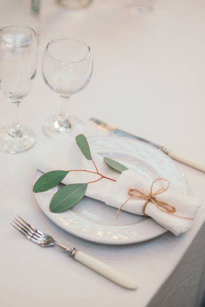 istock Table setting with napkin on empty white plate, wineglasses and cutlery on table, copy space. Place setting at wedding reception. Table served for banquet 2164630738