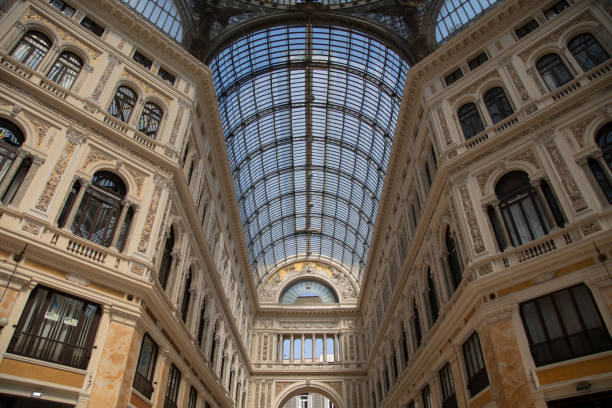 Interior room of a historic museum in Naples, Italy, featuring marble floors, large open doors with balcony light, and classical artwork displayed on the wall. April 27, 2025