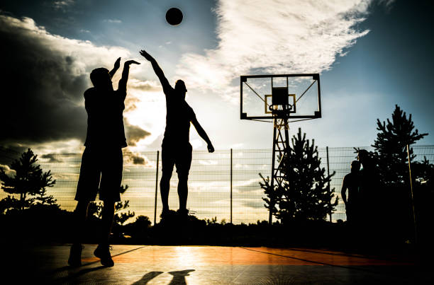 istock Two young men playing basketball 2164630864