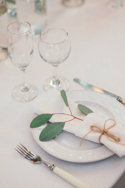 istock Table setting with napkin on empty white plate, wineglasses and cutlery on table, copy space. Place setting at wedding reception. Table served for banquet 2164630889