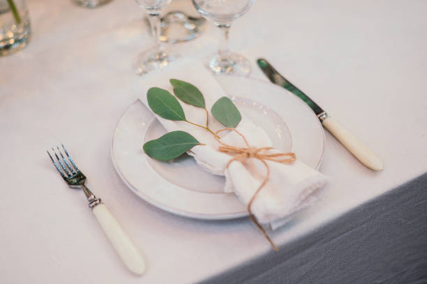 istock Table setting with napkin on empty white plate, wineglasses and cutlery on table, copy space. Place setting at wedding reception. Table served for banquet 2164630937