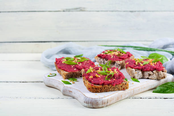 istock Toasts with beetroot, chopped nuts and herbs. Vegan bruschetta with beet 2164630987
