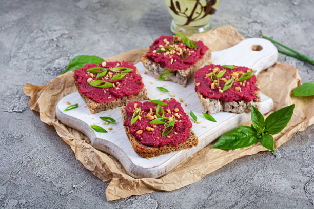 istock Toasts with beetroot, chopped nuts and herbs. Vegan bruschetta with beet 2164630990