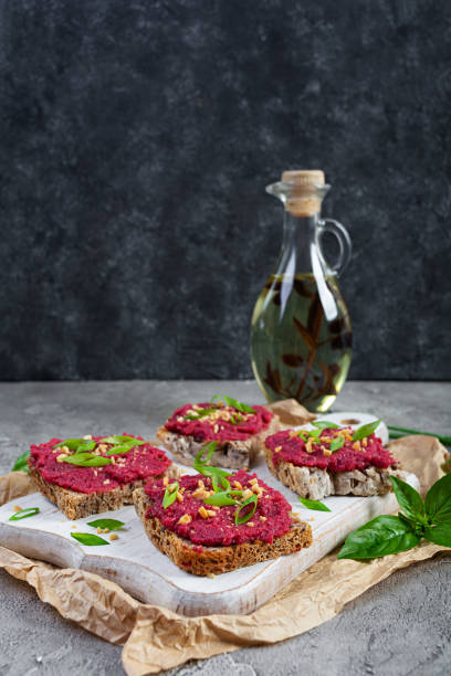 istock Toasts with beetroot, chopped nuts and herbs. Vegan bruschetta with beet 2164630992