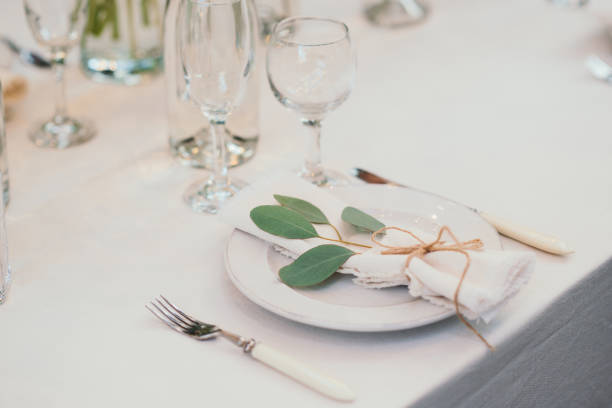 istock Table setting with napkin on empty white plate, wineglasses and cutlery on table, copy space. Place setting at wedding reception. Table served for banquet 2164631114
