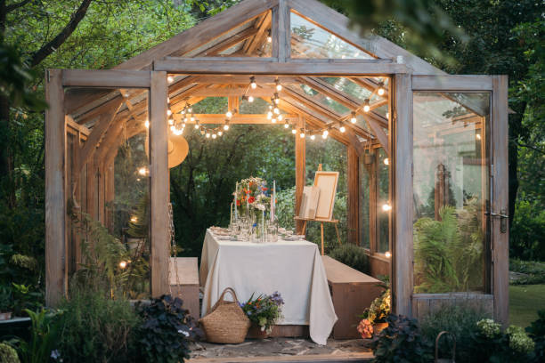 istock decorated greenhouse in trendy wedding setting with dinner table, candles and candle lights. 2164631319