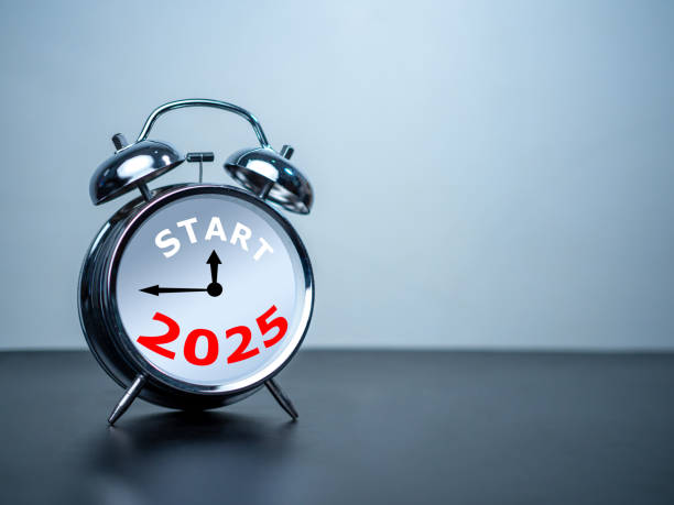istock Start text and 2025 on white alarm clock on black table with copy space for preparation of Merry Christmas and Happy new year concept. Start new business, Start up, New trend to next year concept. 2164631530