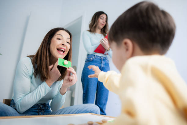 istock Physiotherapist doctor performs exercises to her patients sensory therapy boy 2164637554