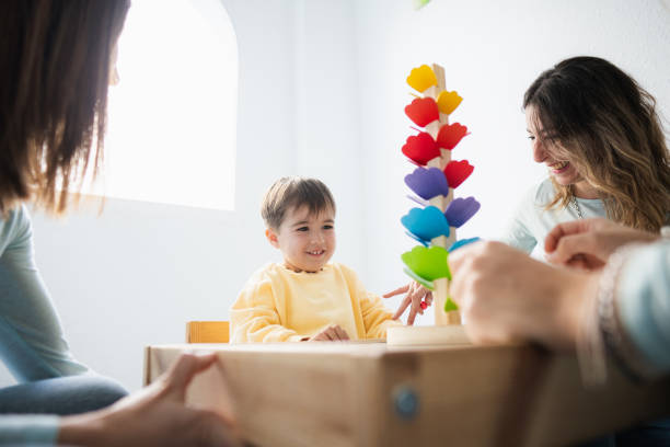 istock Happy kid playing in a special cabinet for children with special needs 2164637556
