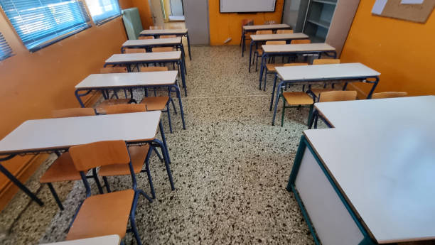 istock class of elemantary school desk chairs board empty 2164637646