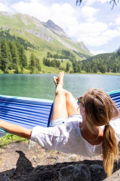 istock Woman Relaxing in Hammock by Serene Lake 2164638516