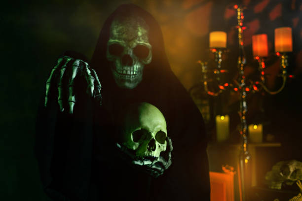 The grim reaper, dressed in a Halloween costume with a dark cloak, holds a scythe in one hand while texting on a smartphone with the other white background