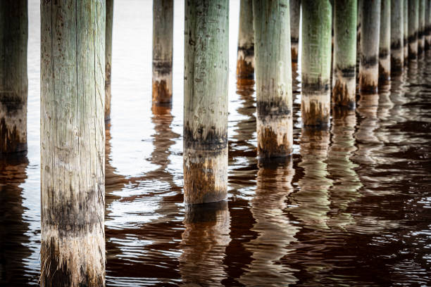 Pillars in a pier. Wooden piles in the Rättvik jetty in Sweden. The long bridge (Långbryggan) in Rättvik is Sweden's longest lake bridge and is one of the world's longest wooden structures.