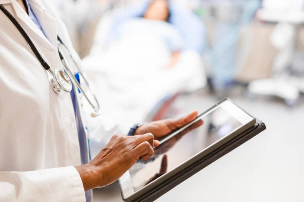 istock Close up of unrecognizable physician typing notes on the digital tablet 2164646145