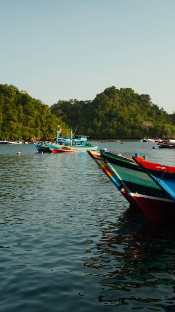 istock wooden boat on clear water 2164646309